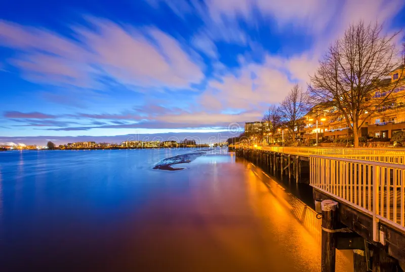 The Fraser River at dusk from the New Westminster Quay, with lights along the boardwalk